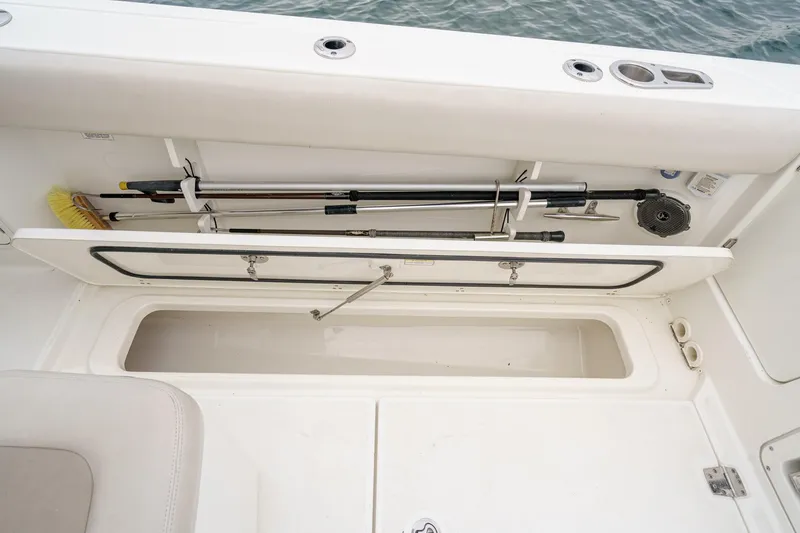  Yacht Photos Pics Storage compartment on a 2019 Boston Whaler 330 Outrage boat, featuring fishing gear.