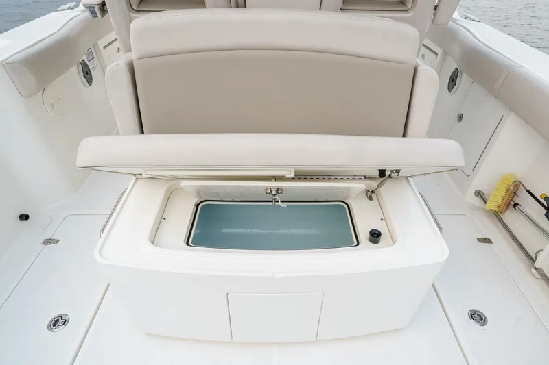  Yacht Photos Pics 2019 Boston Whaler 330 Outrage boat with open storage compartment on deck.