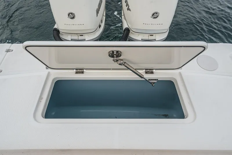  Yacht Photos Pics Open storage compartment on 2019 Boston Whaler 330 Outrage boat, with dual outboard motors.