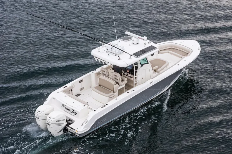  Yacht Photos Pics 2019 Boston Whaler 330 Outrage boat cruising on open water, featuring twin engines.