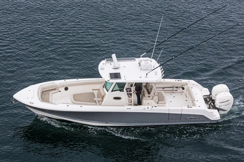  Yacht Photos Pics 2019 Boston Whaler 330 Outrage boat cruising on open water, side view.