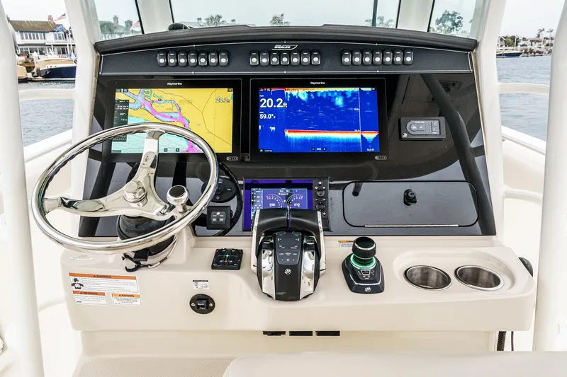  Yacht Photos Pics 2019 Boston Whaler 330 Outrage helm with advanced navigation displays and controls.