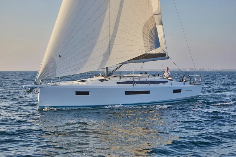  Yacht Photos Pics 2024 Jeanneau Sun Odyssey 410 sailing on open water, showcasing sleek design and performance.
