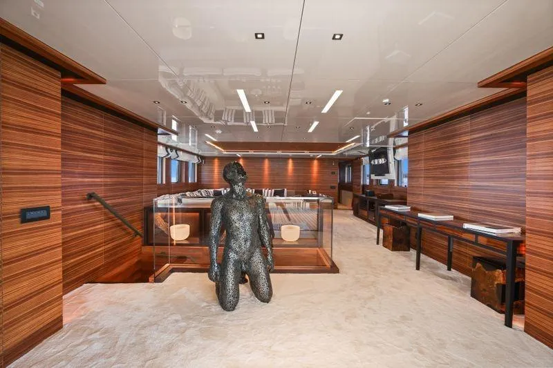 Magna Grecia Yacht Photos Pics Luxurious yacht interior with modern sculpture, wood paneling, and elegant furnishings, Elsflether Werft AG Custom 1986.