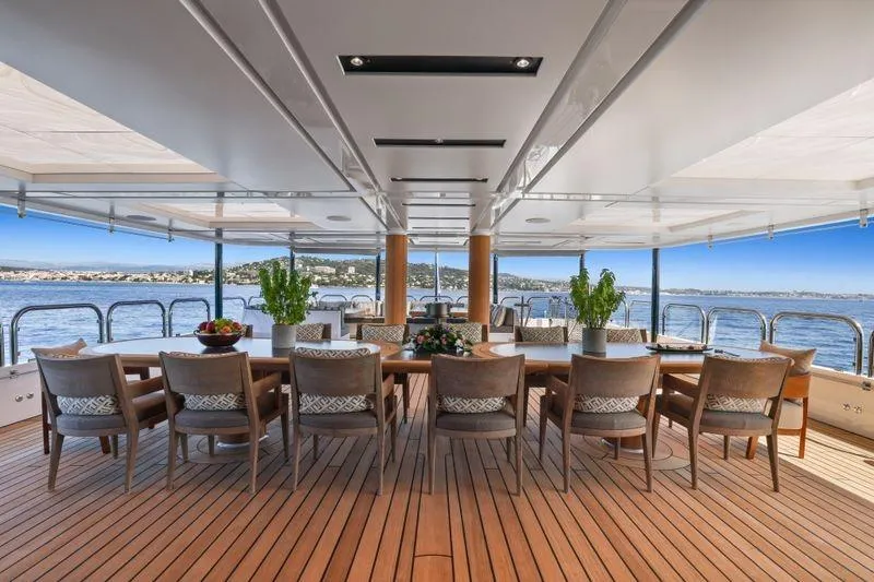 Magna Grecia Yacht Photos Pics Luxurious yacht deck with elegant dining area, Elsflether Werft AG Custom, 1986 model.