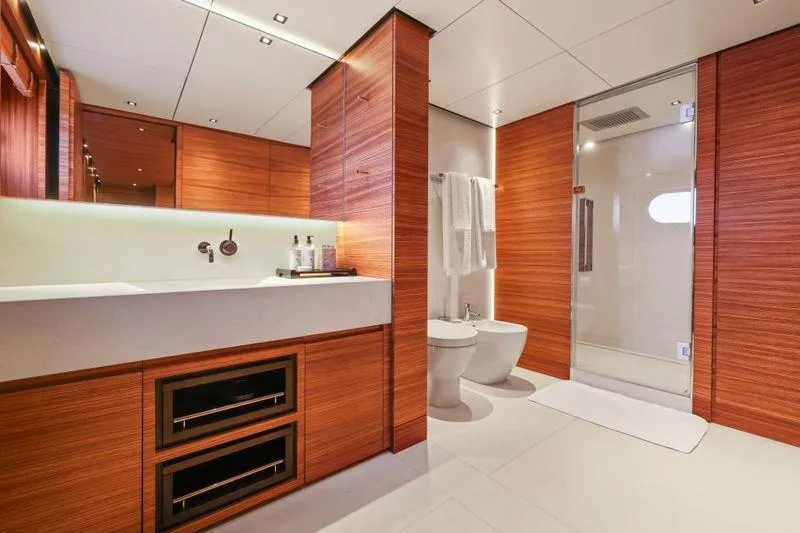 Magna Grecia Yacht Photos Pics Luxurious yacht bathroom with wooden cabinetry, modern fixtures, and spacious shower, Elsflether Werft AG 1986.