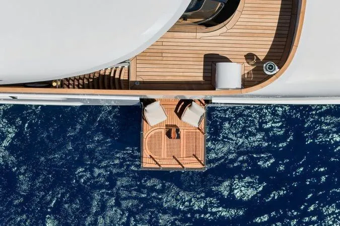 Magna Grecia Yacht Photos Pics Aerial view of 1986 Elsflether Werft AG custom yacht deck over blue ocean.