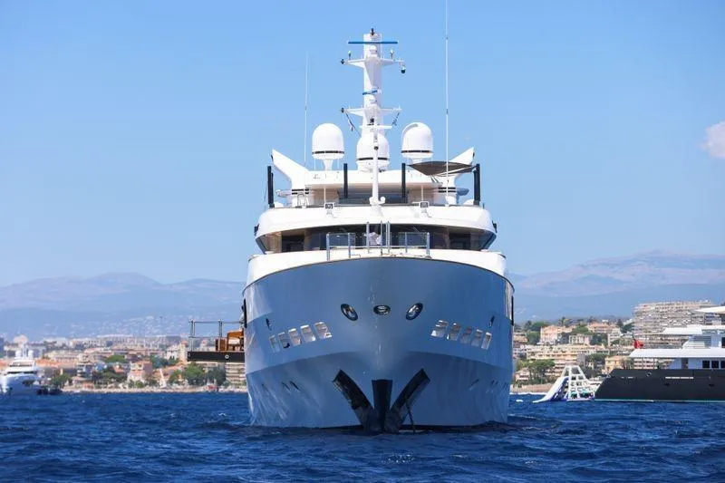 Magna Grecia Yacht Photos Pics Luxurious 1986 Elsflether Werft AG Custom yacht on open water, cityscape background.