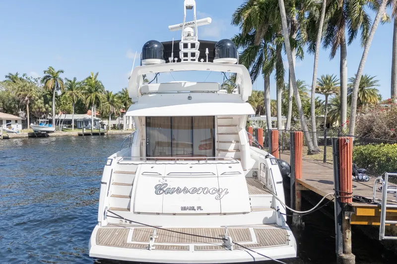 Currency Yacht Photos Pics 2009 Sunseeker Manhattan 60 yacht docked by palm trees in Miami.