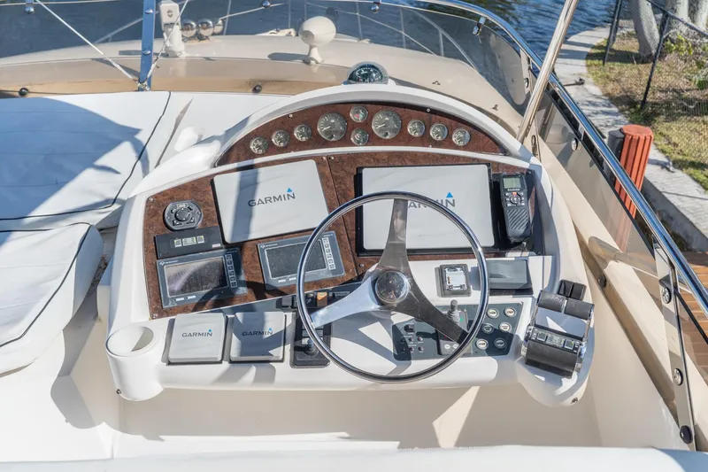 Currency Yacht Photos Pics 2009 Sunseeker Manhattan 60 yacht helm with Garmin navigation systems and controls.