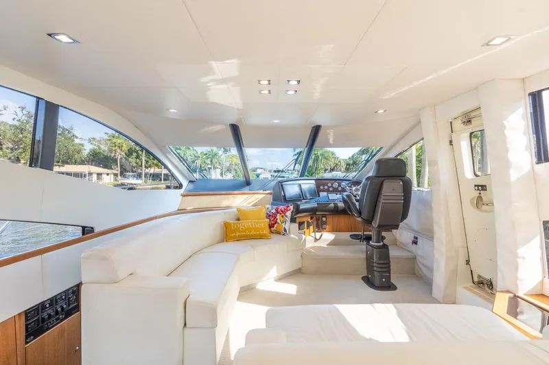 Currency Yacht Photos Pics Luxurious interior of 2009 Sunseeker Manhattan 60 yacht with plush seating and modern helm.