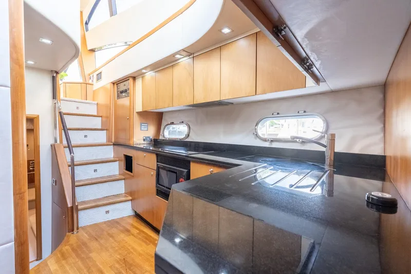 Currency Yacht Photos Pics Luxurious 2009 Sunseeker Manhattan 60 yacht interior with modern kitchen and elegant staircase.