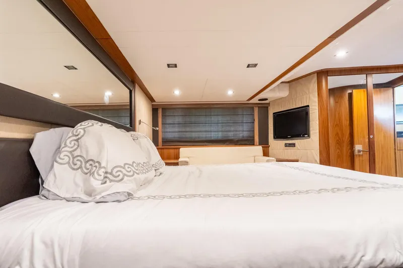 Currency Yacht Photos Pics Luxurious bedroom interior of 2009 Sunseeker Manhattan 60 yacht with elegant bedding and modern decor.