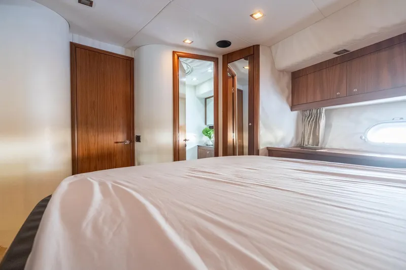 Currency Yacht Photos Pics Luxurious bedroom interior of 2009 Sunseeker Manhattan 60 yacht with wooden accents.