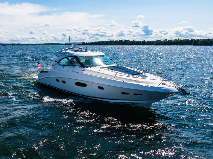 Hav-n Fun Yacht Photos Pics 2009 Sea Ray 470 Sundancer yacht cruising on a sunny day with clear skies.