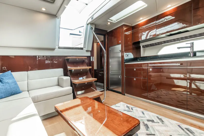 Hav-n Fun Yacht Photos Pics Luxurious interior of 2009 Sea Ray 470 Sundancer yacht with modern kitchen and seating area.