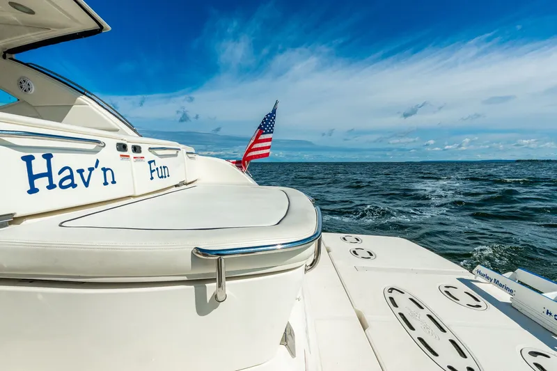 Hav-n Fun Yacht Photos Pics 2009 Sea Ray 470 Sundancer yacht on open water, American flag waving.