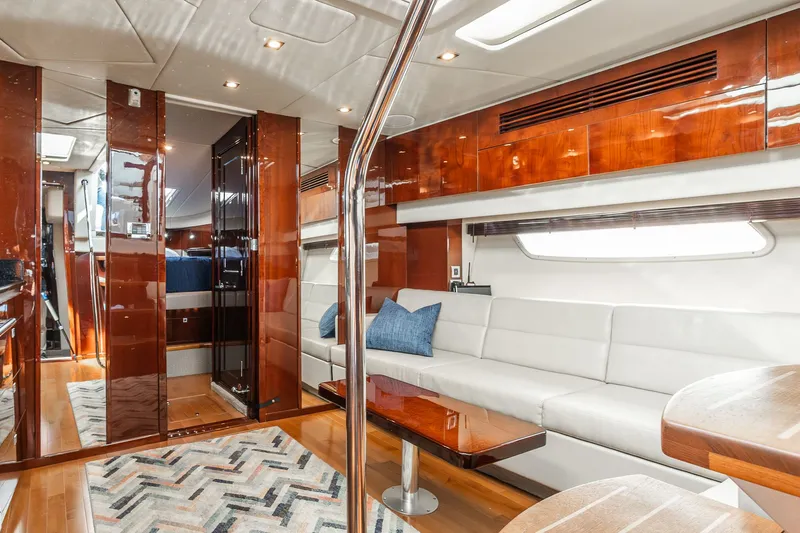 Hav-n Fun Yacht Photos Pics Luxurious interior of 2009 Sea Ray 470 Sundancer yacht with elegant wood finishes and white seating.
