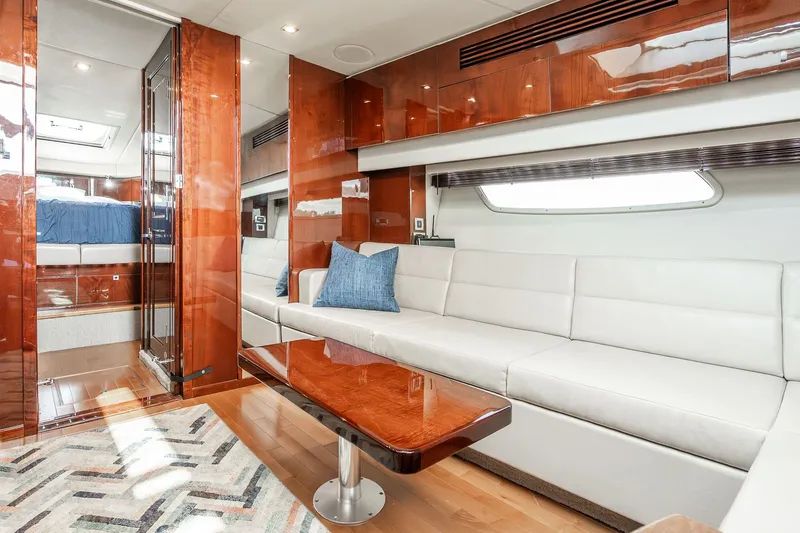 Hav-n Fun Yacht Photos Pics Luxurious interior of 2009 Sea Ray 470 Sundancer yacht with white seating and wooden accents.