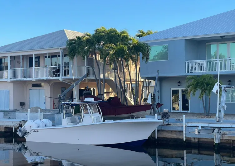 Avery Ann Yacht Photos Pics 2023 Front Runner 33 Center Console boat docked near waterfront homes.