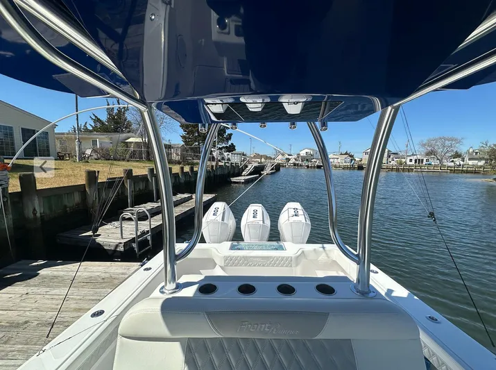Avery Ann Yacht Photos Pics 2023 Front Runner 33 Center Console boat docked by a serene waterfront.