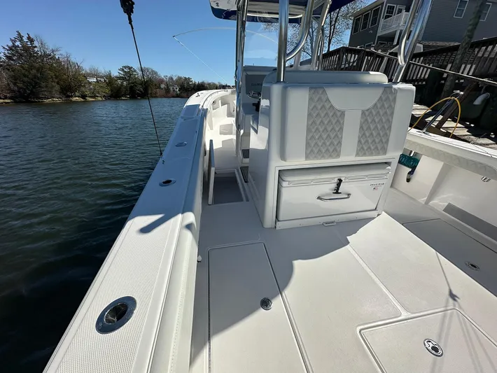 Avery Ann Yacht Photos Pics 2023 Front Runner 33 Center Console boat, sleek white deck, docked by calm waters.