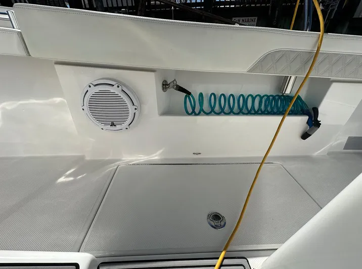 Avery Ann Yacht Photos Pics 2023 Front Runner 33 Center Console boat deck with speaker and coiled hose.