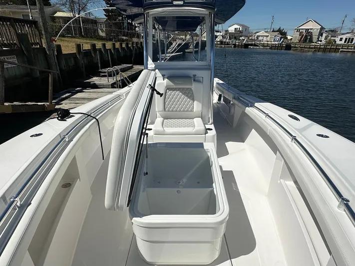 Avery Ann Yacht Photos Pics 2023 Front Runner 33 Center Console boat with open storage, docked by a waterfront.