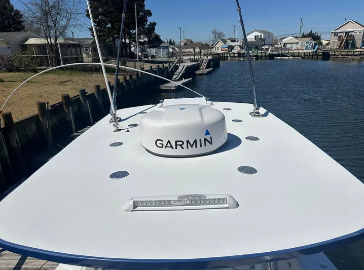 Avery Ann Yacht Photos Pics 2023 Front Runner 33 Center Console boat with Garmin radar on deck, docked by a canal.