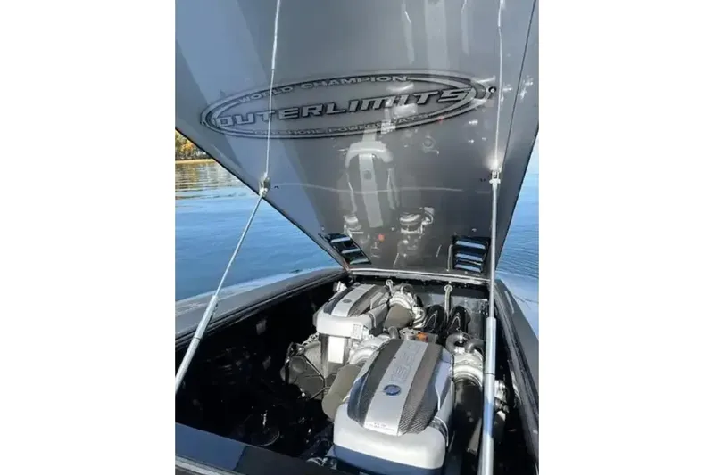  Yacht Photos Pics 2020 Outerlimits SL-50 boat engine compartment with open hatch on a calm lake.