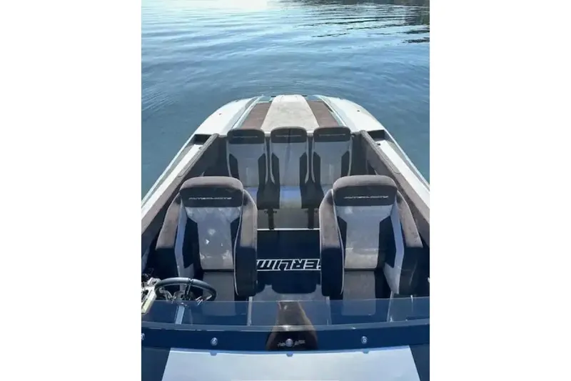  Yacht Photos Pics 2020 Outerlimits SL-50 boat interior with sleek seating on calm water.