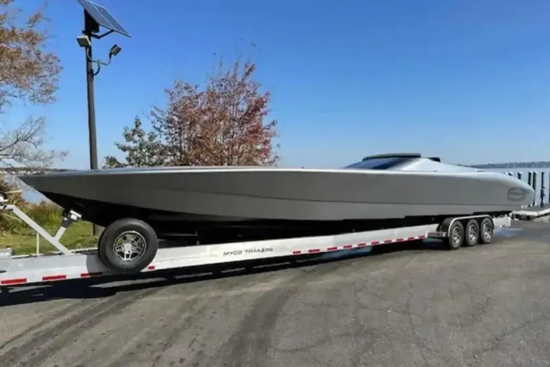  Yacht Photos Pics 2020 Outerlimits SL-50 powerboat on trailer, parked outdoors under clear sky.