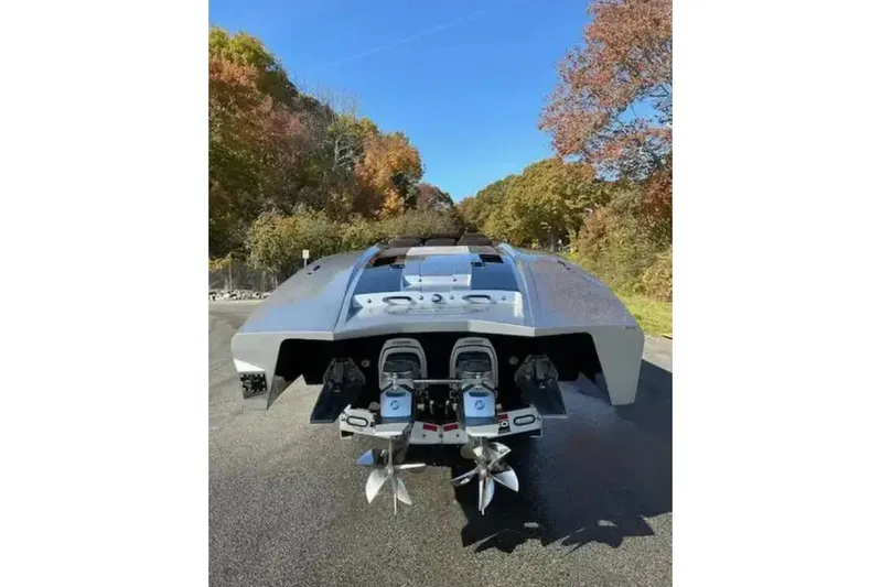  Yacht Photos Pics 2020 Outerlimits SL-50 powerboat with dual engines, parked on a scenic road.