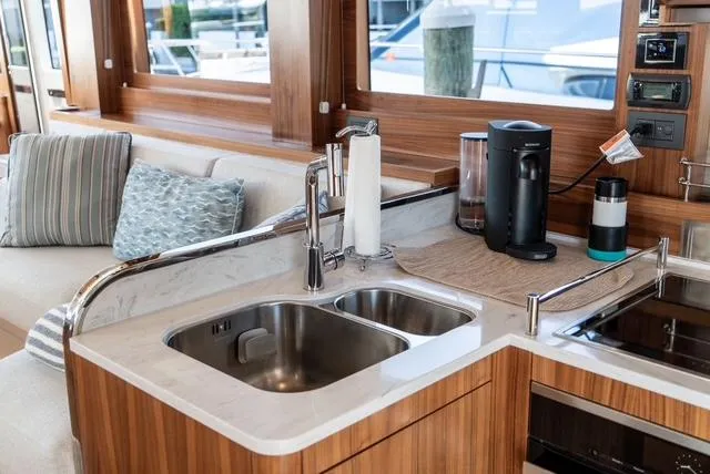 Freedom Yacht Photos Pics Modern kitchen area in 2022 Sirena 58 Flybridge yacht with sink and appliances.