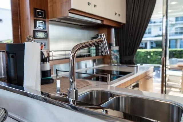 Freedom Yacht Photos Pics Modern kitchen interior on 2022 Sirena 58 Flybridge yacht, featuring sleek sink and appliances.