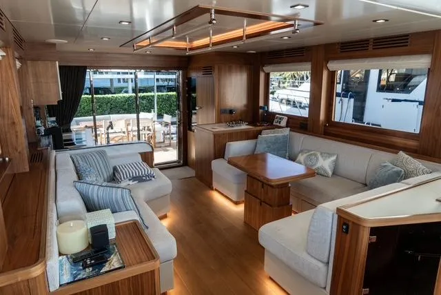 Freedom Yacht Photos Pics Luxurious interior of 2022 Sirena 58 Flybridge yacht with elegant seating and wooden accents.