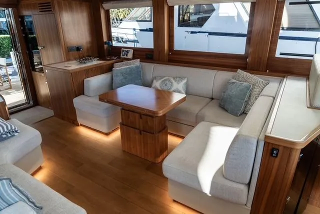 Freedom Yacht Photos Pics Luxurious interior of 2022 Sirena 58 Flybridge yacht with elegant seating and wooden accents.