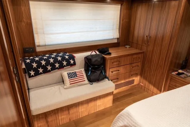 Freedom Yacht Photos Pics Luxurious 2022 Sirena 58 Flybridge cabin with wooden interior and American-themed decor.