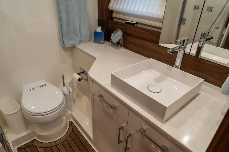 Freedom Yacht Photos Pics Luxurious bathroom in 2022 Sirena 58 Flybridge yacht with modern fixtures and elegant design.