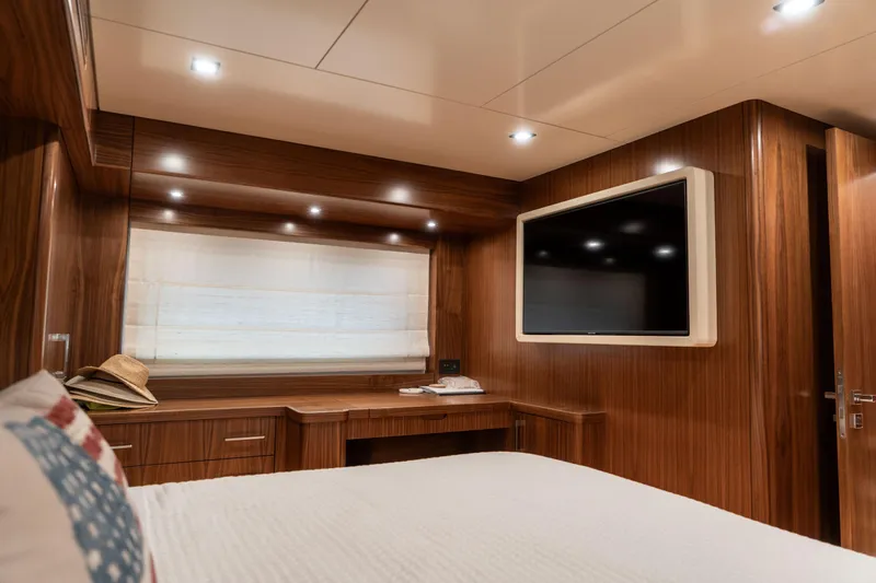 Freedom Yacht Photos Pics Luxurious cabin interior of 2022 Sirena 58 Flybridge yacht with wood finish and modern amenities.