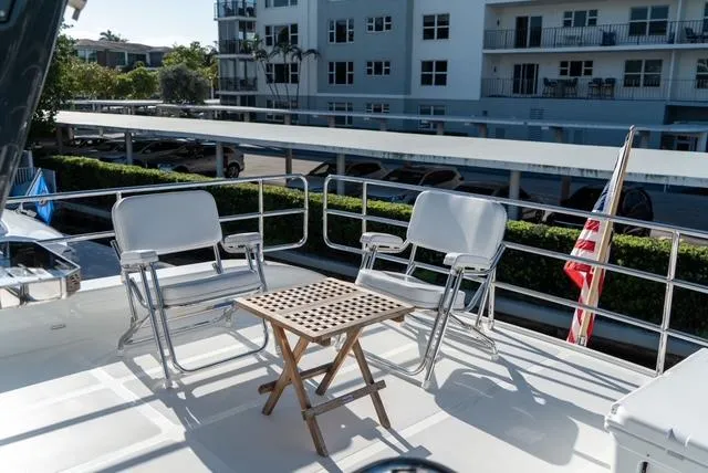 Freedom Yacht Photos Pics Flybridge deck of 2022 Sirena 58 yacht with chairs and table.