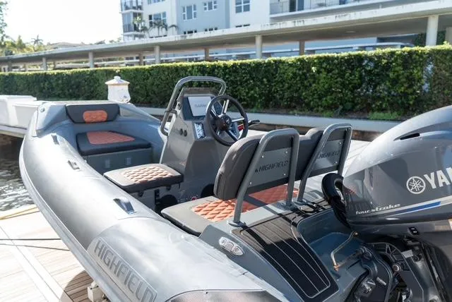 Freedom Yacht Photos Pics 2022 Sirena 58 Flybridge with Highfield tender and Yamaha outboard engine, docked by greenery.