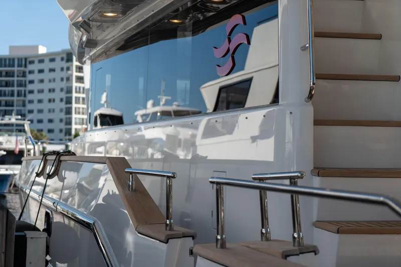 Freedom Yacht Photos Pics 2022 Sirena 58 Flybridge yacht docked, showcasing sleek design and modern architecture.