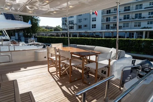 Freedom Yacht Photos Pics Luxurious 2022 Sirena 58 Flybridge yacht deck with seating and dining area.