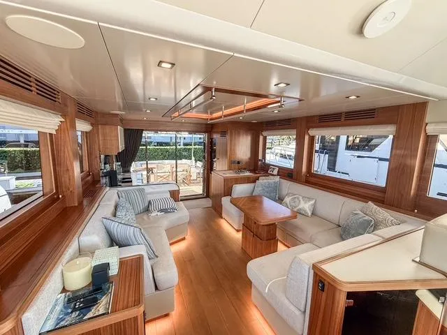 Freedom Yacht Photos Pics Luxurious interior of 2022 Sirena 58 Flybridge yacht with elegant wood finishes and plush seating.