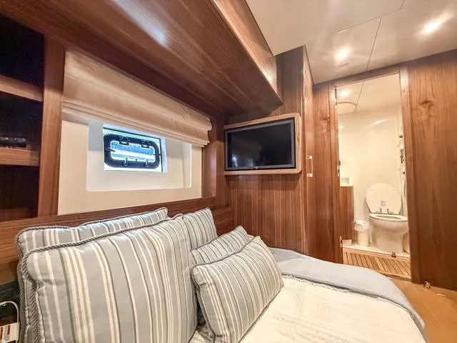 Freedom Yacht Photos Pics Luxurious cabin interior of 2022 Sirena 58 Flybridge yacht with ensuite bathroom.