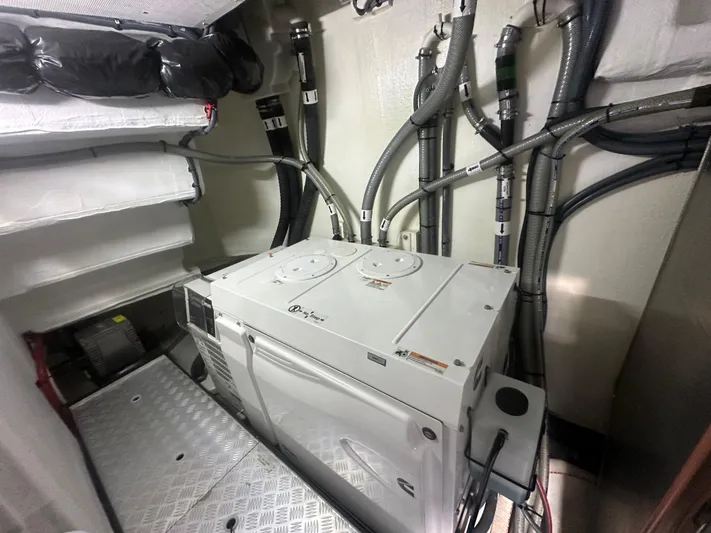 Freedom Yacht Photos Pics Engine room of 2022 Sirena 58 Flybridge yacht, featuring mechanical equipment and wiring.