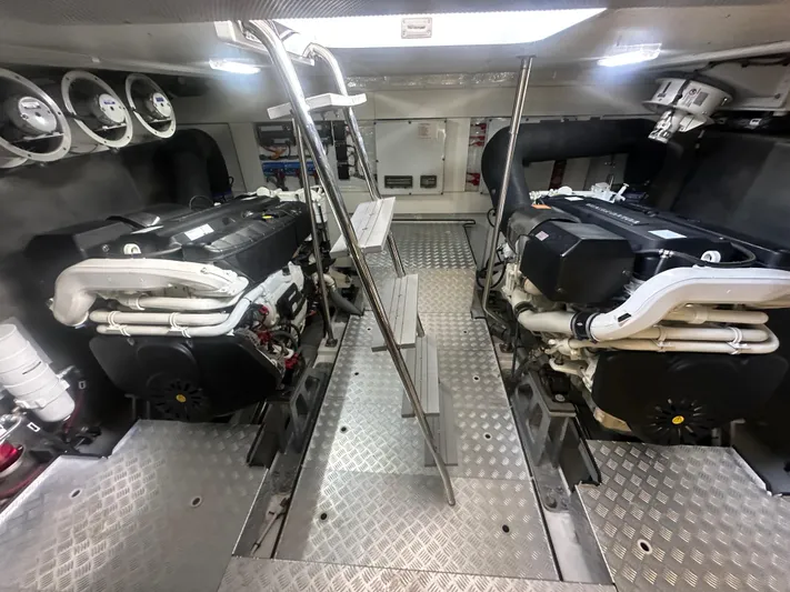 Freedom Yacht Photos Pics Engine room of 2022 Sirena 58 Flybridge yacht, featuring dual engines and metallic flooring.