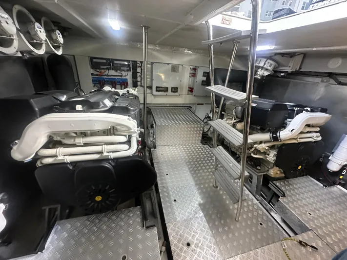 Freedom Yacht Photos Pics Engine room of 2022 Sirena 58 Flybridge yacht with dual engines and metallic flooring.
