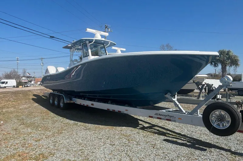  Yacht Photos Pics 2026 Yellowfin 36 Offshore boat on trailer, parked outdoors under clear blue sky.